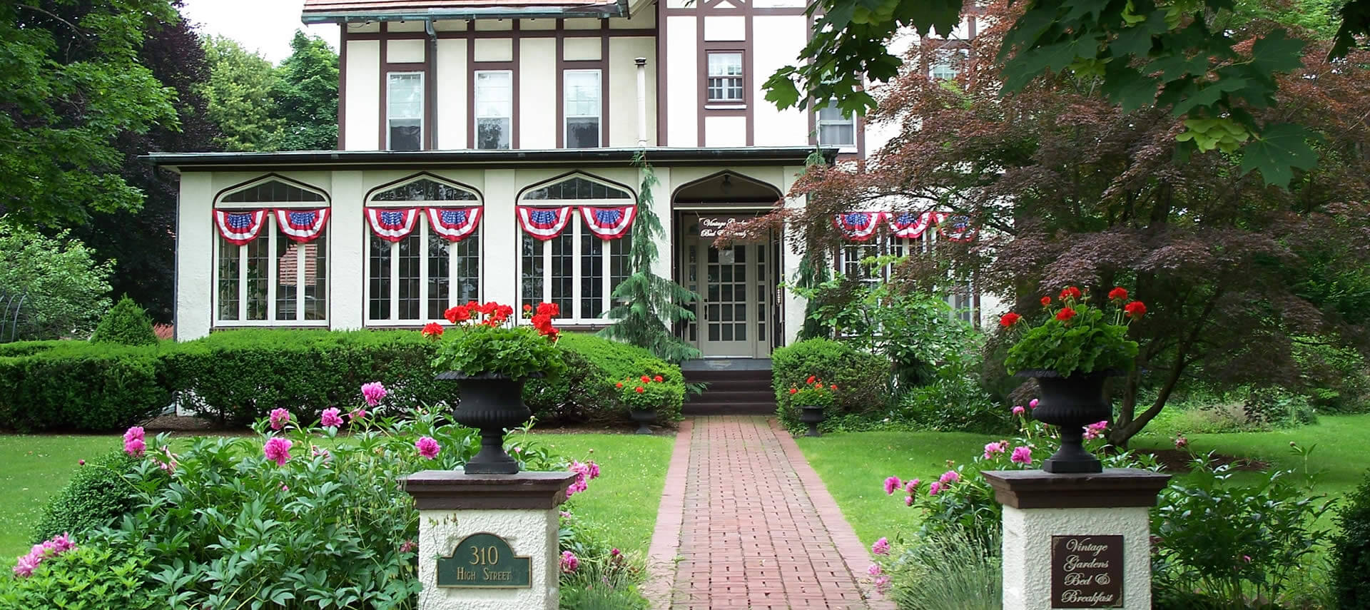 Large Tudor home decorated with red white and blue bunting.