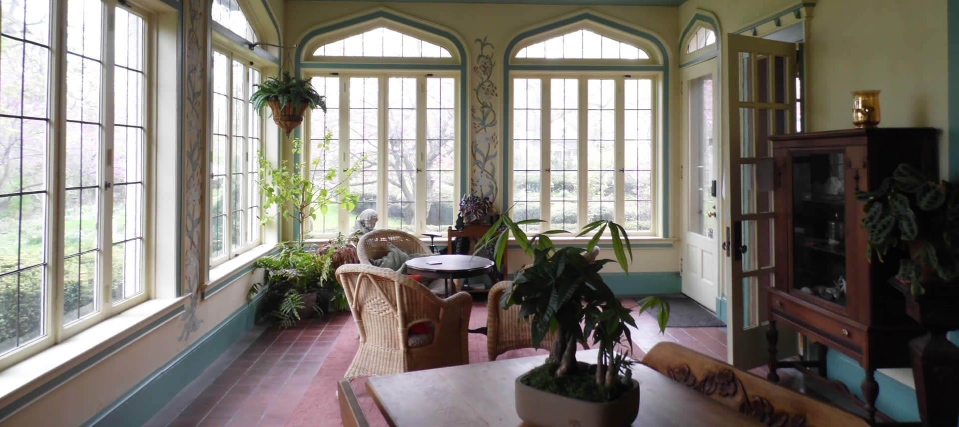 Sun porch with unique windows and tables and chairs.